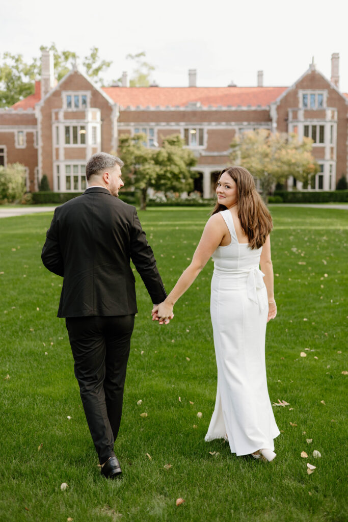 Engaged couple walking towards the Waveny House Mansion in New Canaan, Connecticut