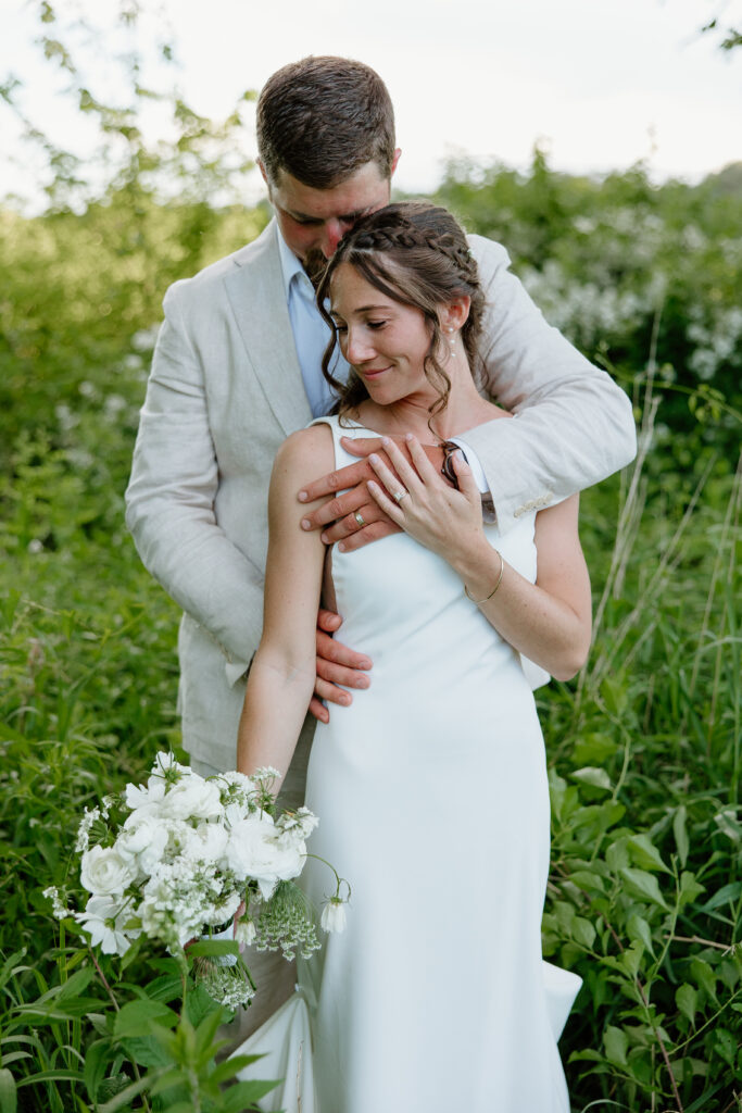 Bride and Groom embracing on their wedding day for golden hour portraits in Tolland, CT