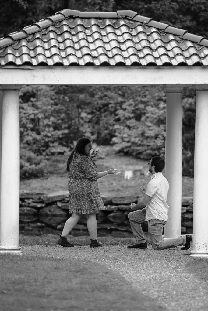 Man proposing to a woman under a gazebo at Wickham Park in Manchester, CT