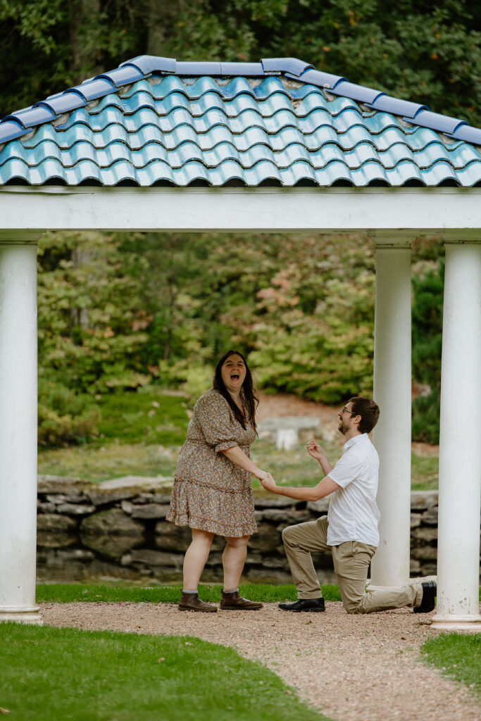 Man proposing to a woman under a gazebo at Wickham Park in Manchester, CT