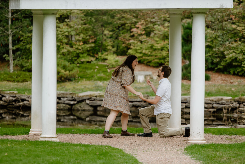 Man proposing to a woman under a gazebo at Wickham Park in Manchester, CT