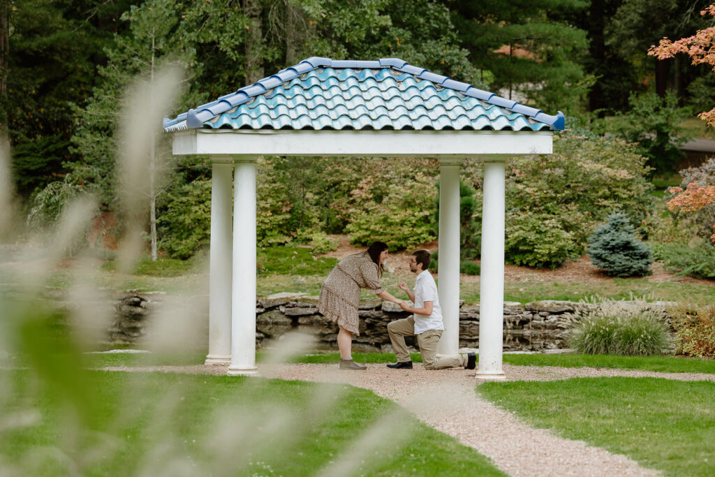 Man proposing to a woman under a gazebo at Wickham Park in Manchester, CT