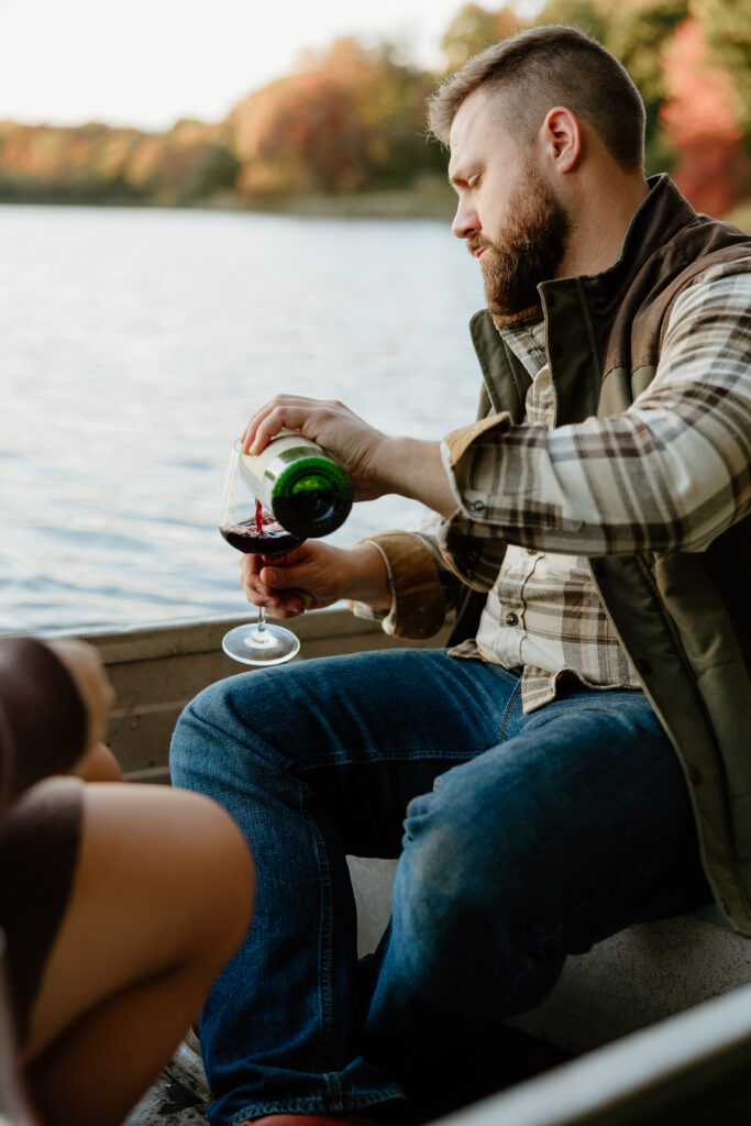 couple enjoying wine out on a boat during an adventurous couples session