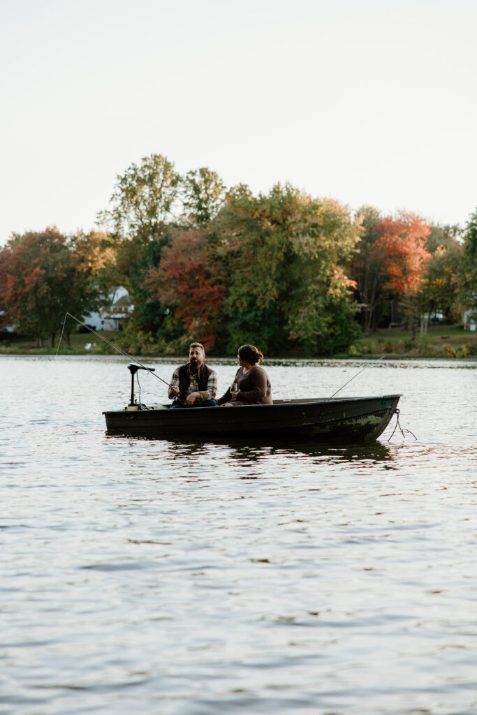 couple fishing out on a boat during an adventurous couples session