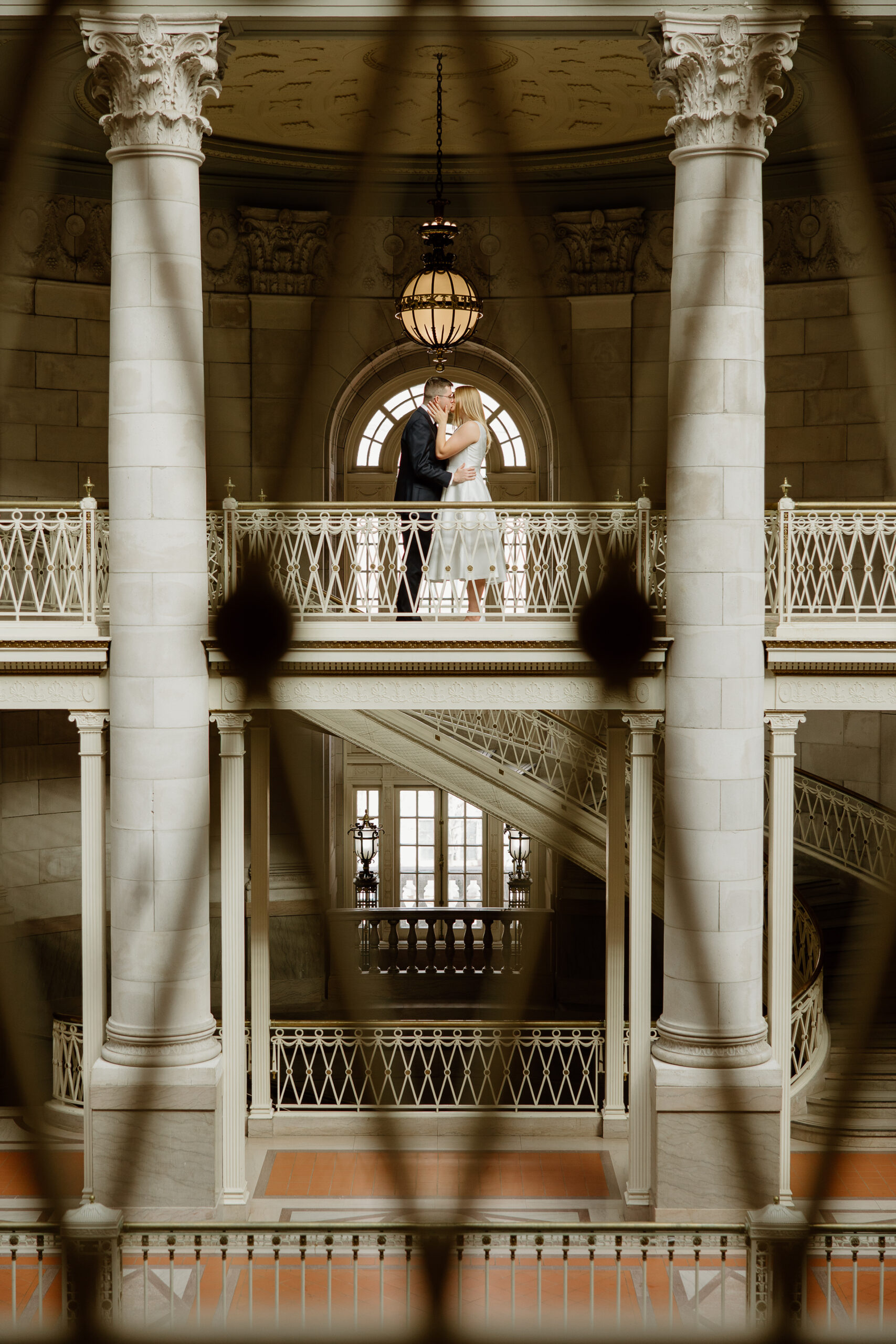 A couple kissing on the third floor of Hartford City Hall for their romantic engagement session.