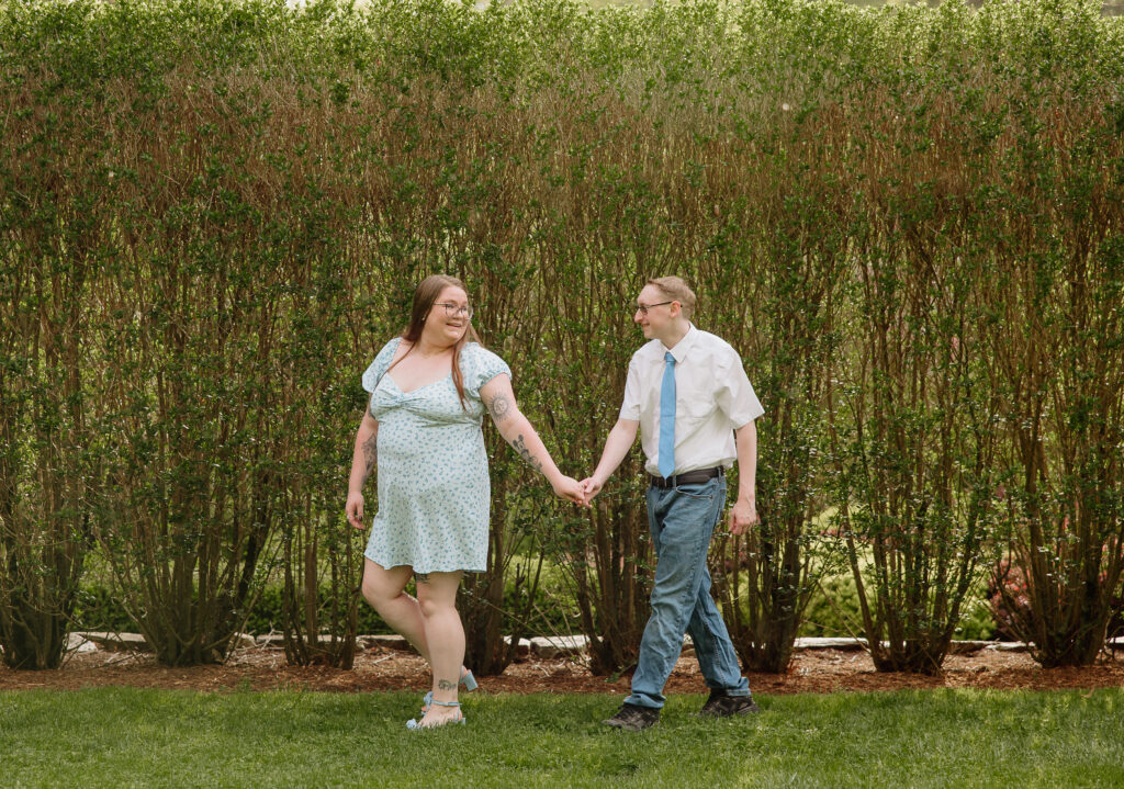 Engaged couple walking together at Wickham Park