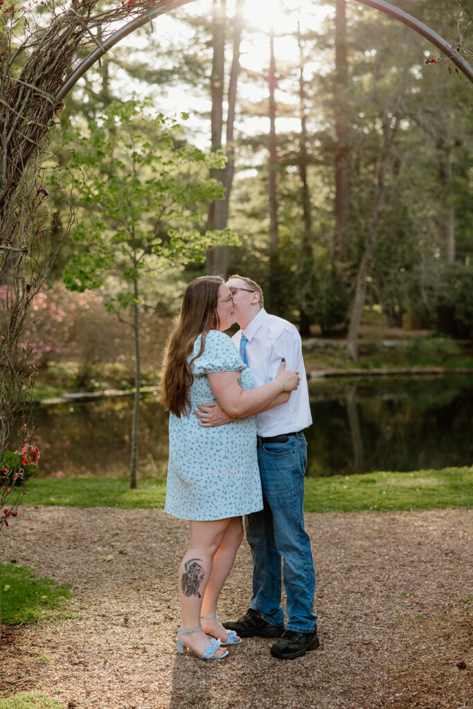 Engaged couple embracing in the gardens at Wickham Park