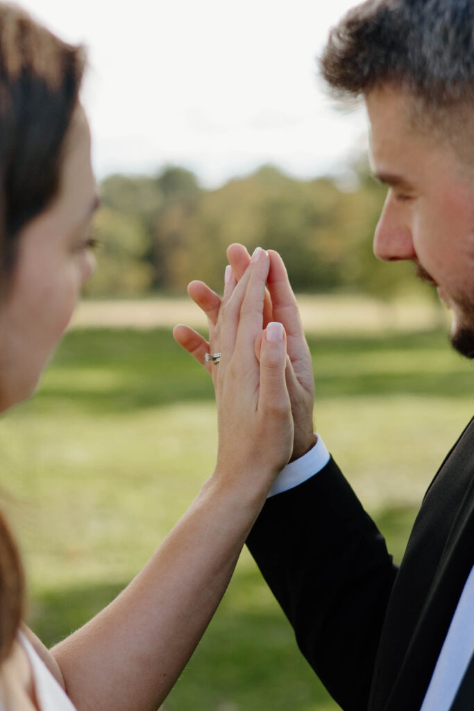 Engaged couple holding hands at Waveny Park